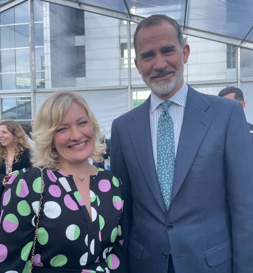 Man and woman smiling, woman in polka-dot dress