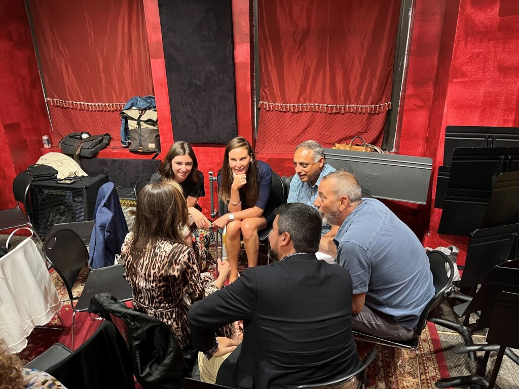 Group of people sitting and talking together.